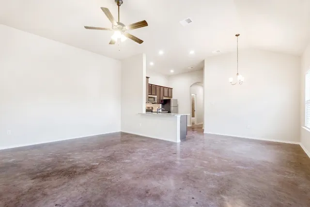 a view of a kitchen with a sink and a refrigerator