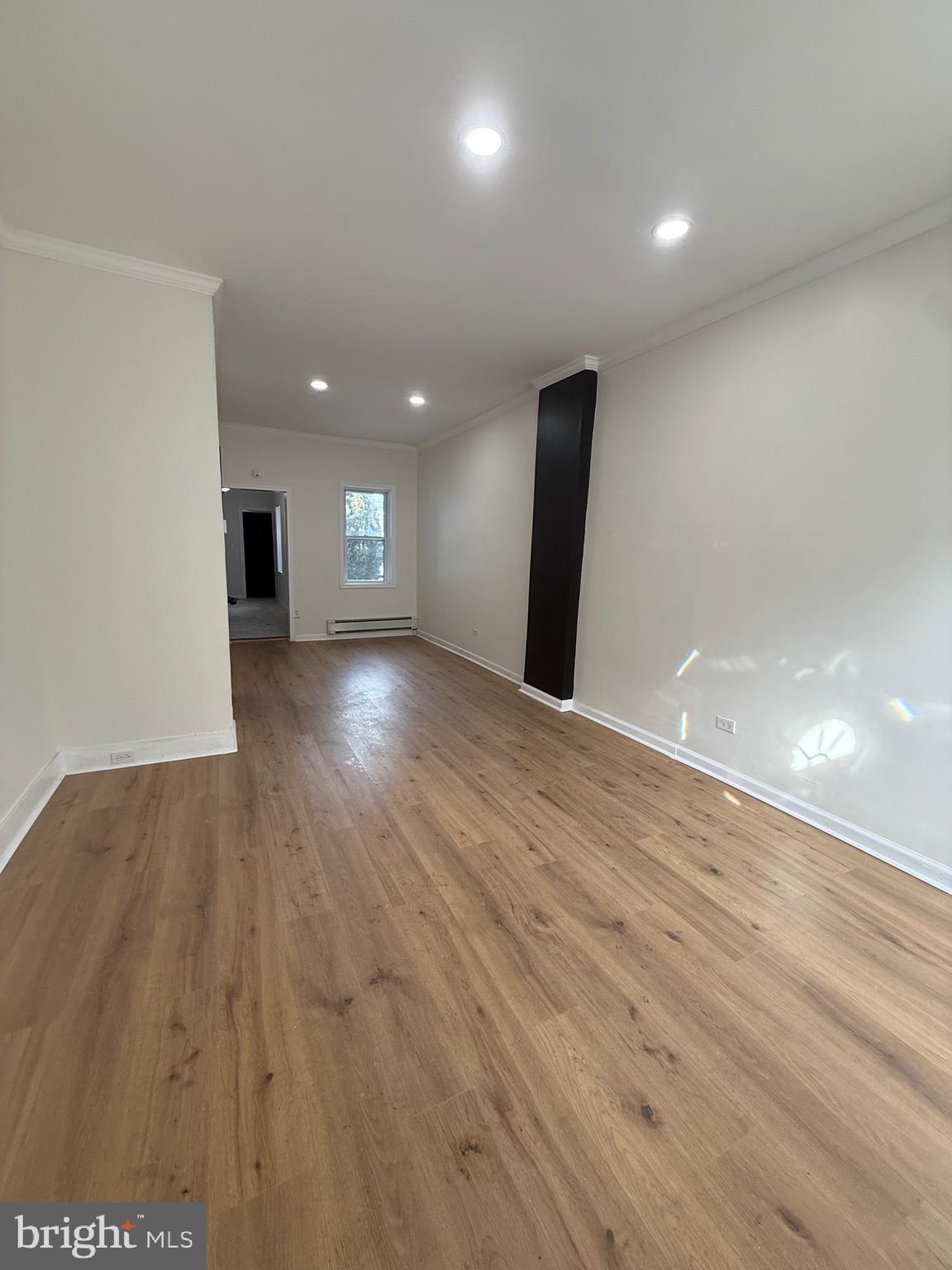 542 Moss Street Reading, PA 19604 - Photo 4 of 19 an empty room with wooden floor and windows