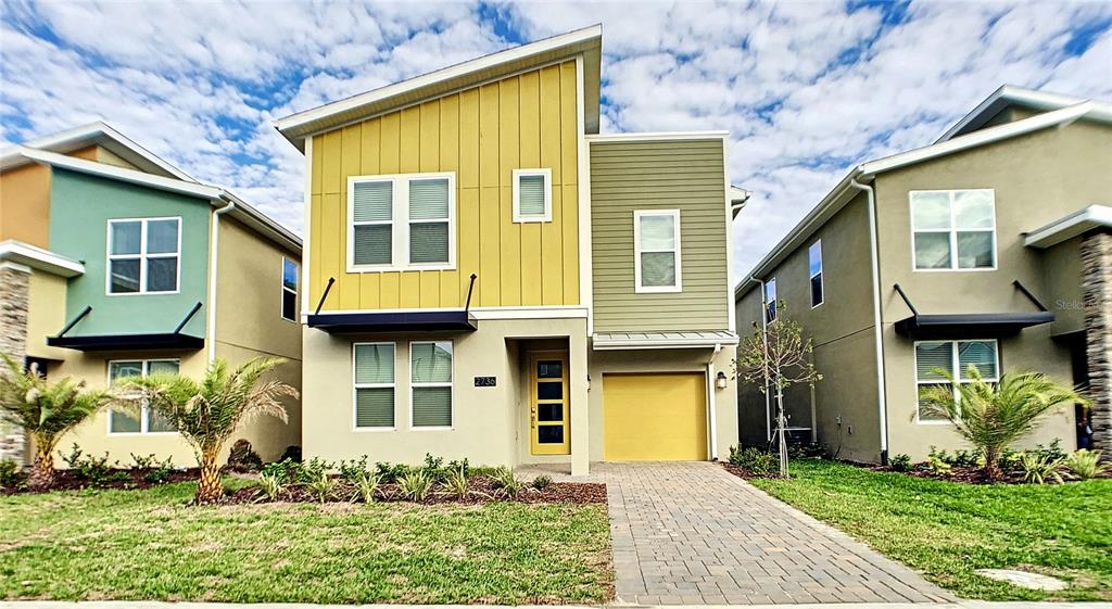 2736 Bookmark Drive Kissimmee, FL 34746 - Photo 1 of 35 a front view of a house with a yard