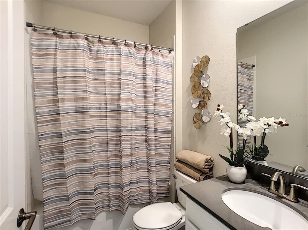 2736 Bookmark Drive Kissimmee, FL 34746 - Photo 11 of 35 a bathroom with a sink toilet and shower