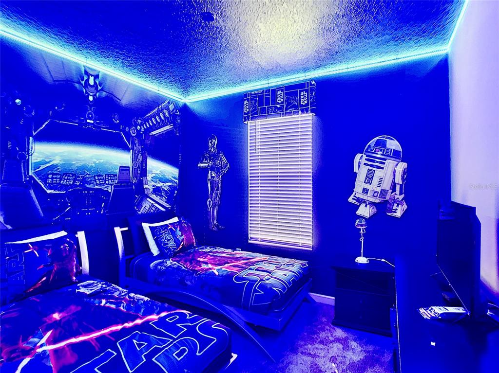 2736 Bookmark Drive Kissimmee, FL 34746 - Photo 12 of 35 a bedroom with a large bed and a lamp