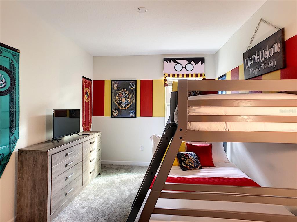 2736 Bookmark Drive Kissimmee, FL 34746 - Photo 14 of 35 a bedroom with a bed and a flat screen tv