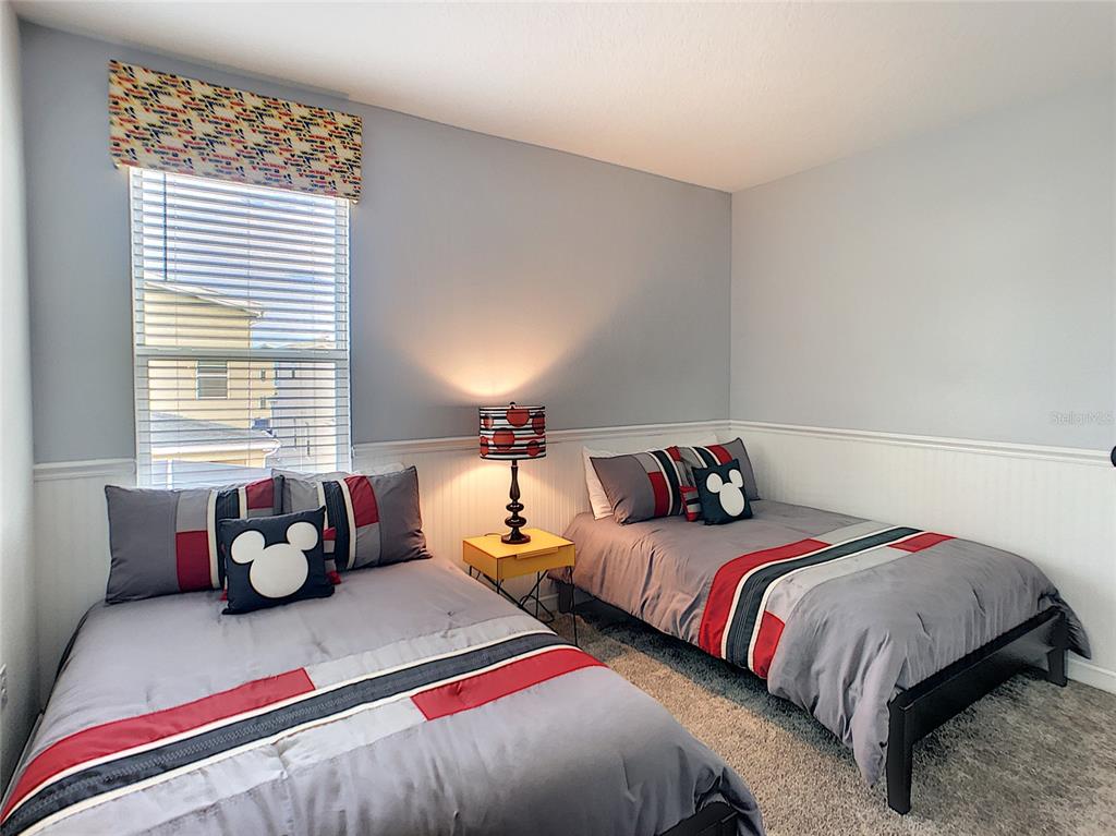 2736 Bookmark Drive Kissimmee, FL 34746 - Photo 16 of 35 a bedroom with two beds and a large window
