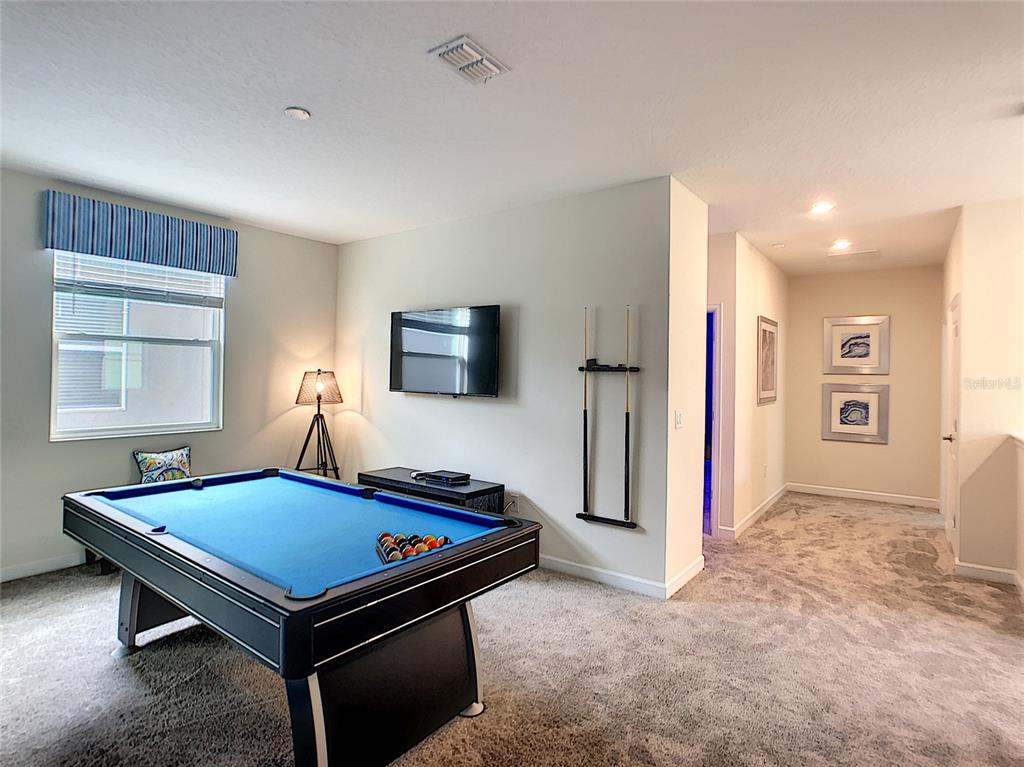 2736 Bookmark Drive Kissimmee, FL 34746 - Photo 19 of 35 a room with pool table and a flat screen tv