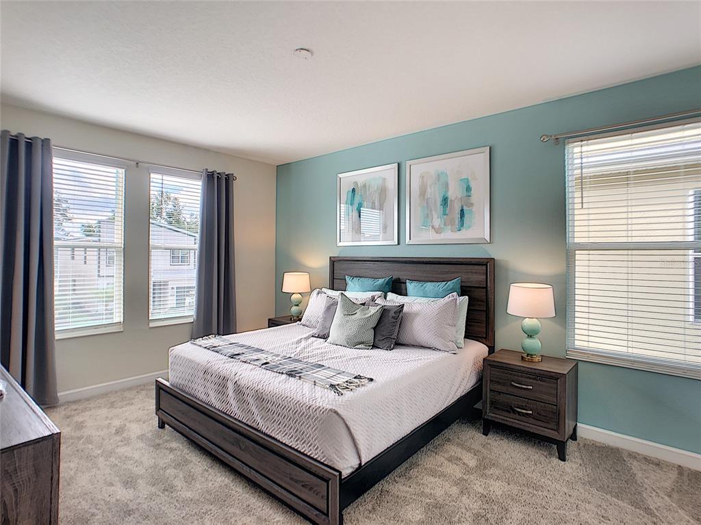 2736 Bookmark Drive Kissimmee, FL 34746 - Photo 21 of 35 a bedroom with a bed lamp and a window