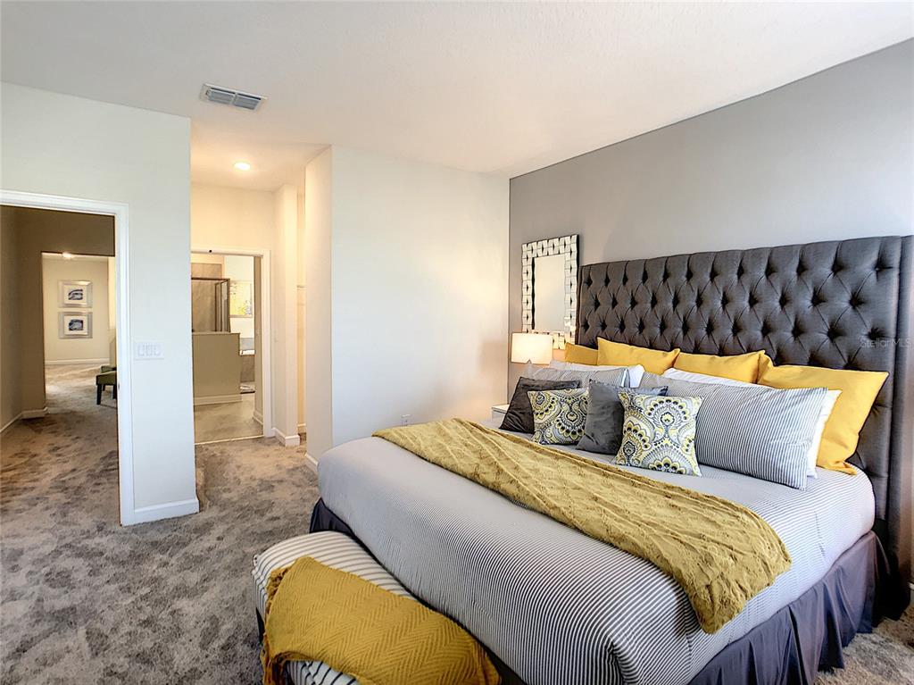 2736 Bookmark Drive Kissimmee, FL 34746 - Photo 25 of 35 a bedroom with a bed and painting on the wall