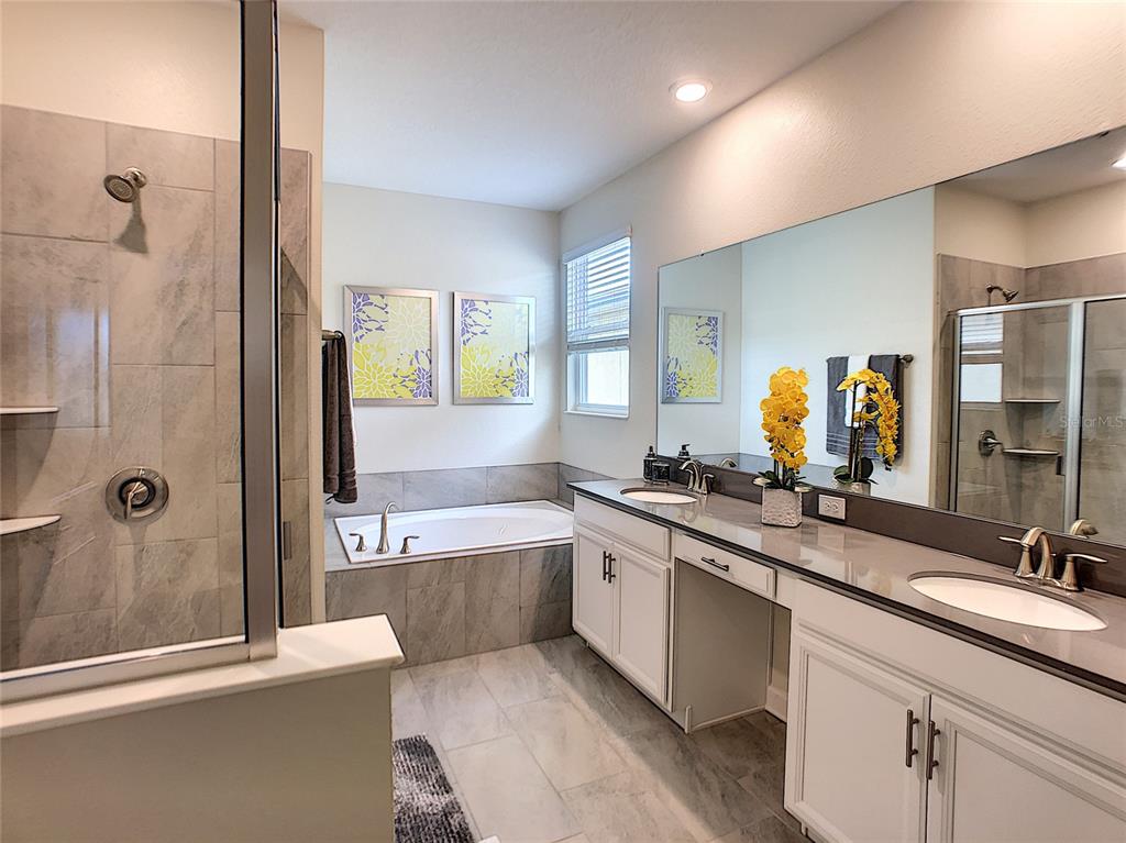 2736 Bookmark Drive Kissimmee, FL 34746 - Photo 26 of 35 a bathroom with a granite countertop tub sink toilet and mirror