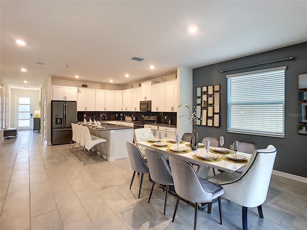 2736 Bookmark Drive Kissimmee, FL 34746 - Photo 3 of 35 a kitchen with a dining table chairs and view kitchen
