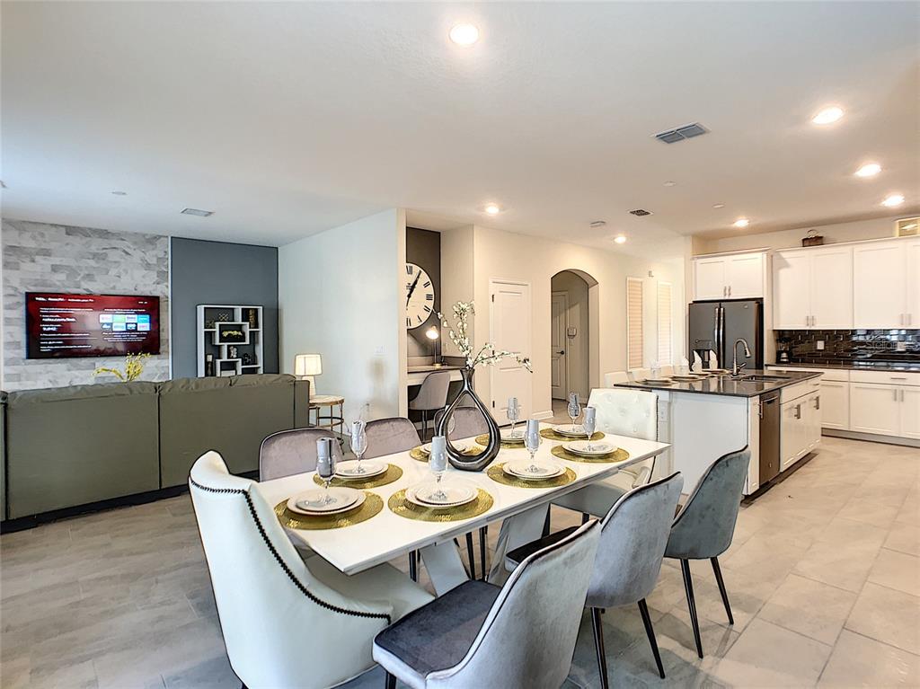 2736 Bookmark Drive Kissimmee, FL 34746 - Photo 6 of 35 a view of a dining room with furniture and wooden floor