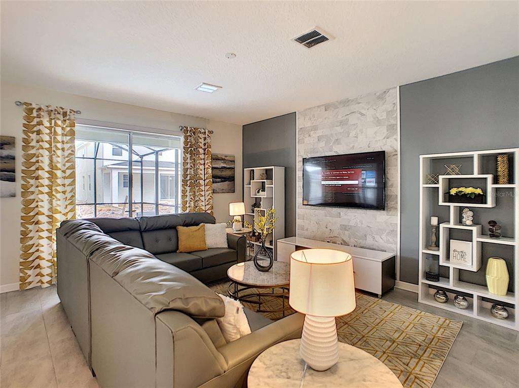 2736 Bookmark Drive Kissimmee, FL 34746 - Photo 7 of 35 a living room with furniture and a wooden floor