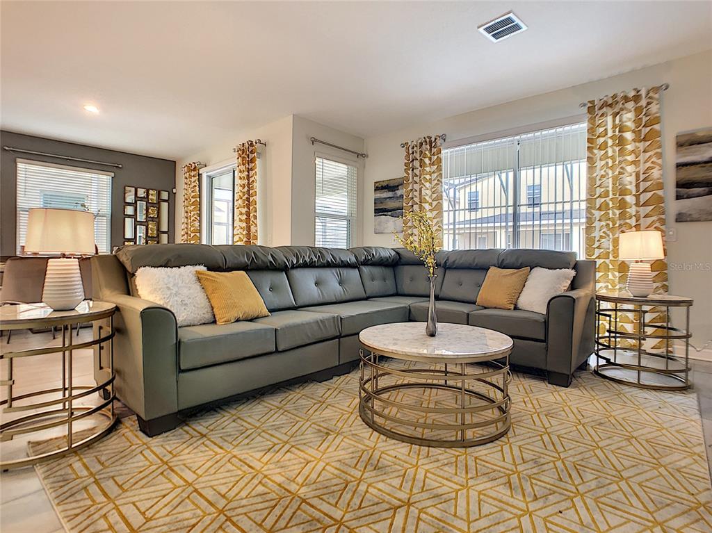 2736 Bookmark Drive Kissimmee, FL 34746 - Photo 8 of 35 a living room with furniture and a large window