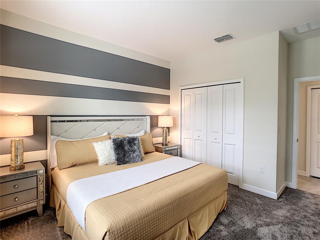 2736 Bookmark Drive Kissimmee, FL 34746 - Photo 10 of 35 a bedroom with a bed and a night stand
