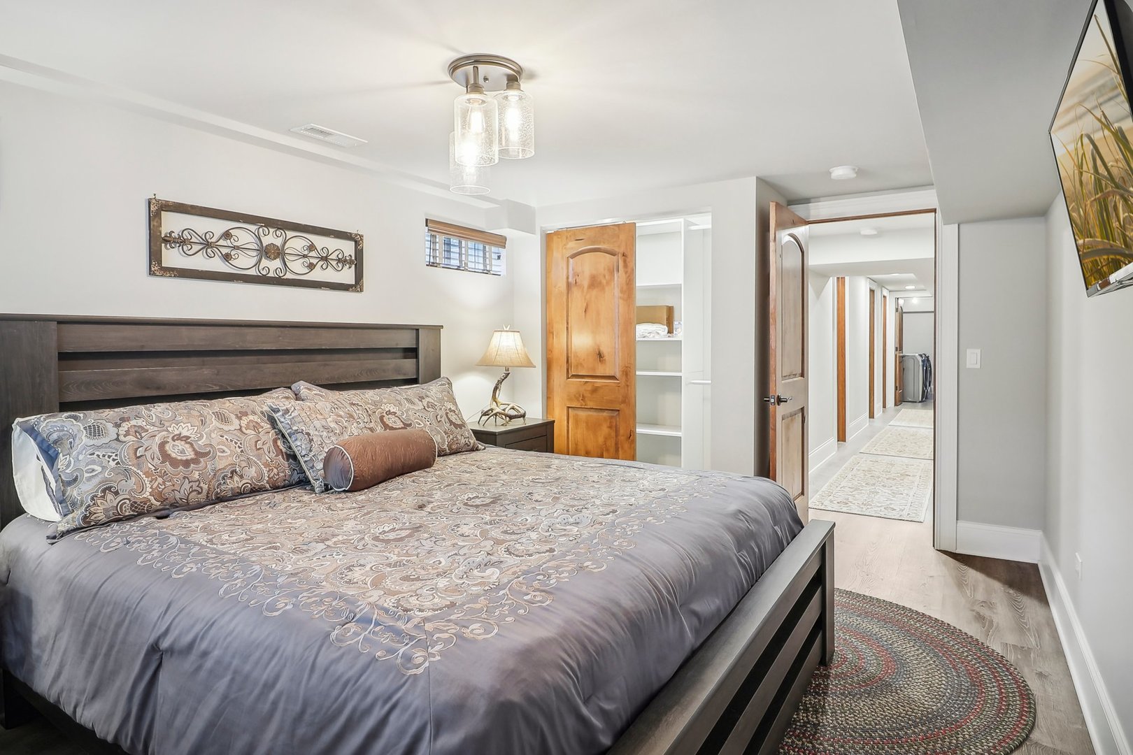 22517 Grange Road Marengo, IL 60152 - Photo 32 of 39 a bedroom with a large bed and a chandelier