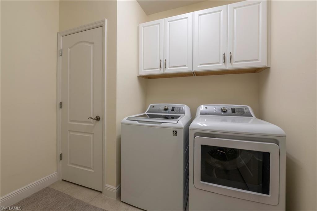 6954 Avalon Circle, Unit 702 Naples, FL 34112 - Photo 11 of 40 a utility room with dryer and washer