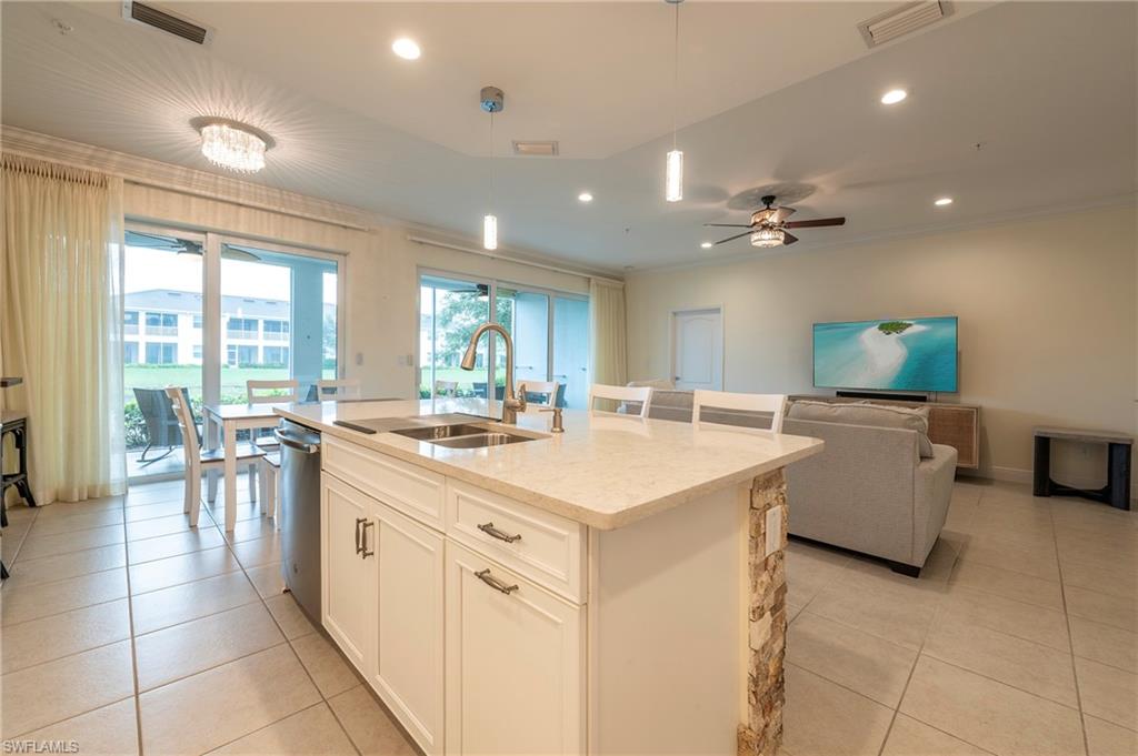 6954 Avalon Circle, Unit 702 Naples, FL 34112 - Photo 17 of 40 a large white kitchen with a large window
