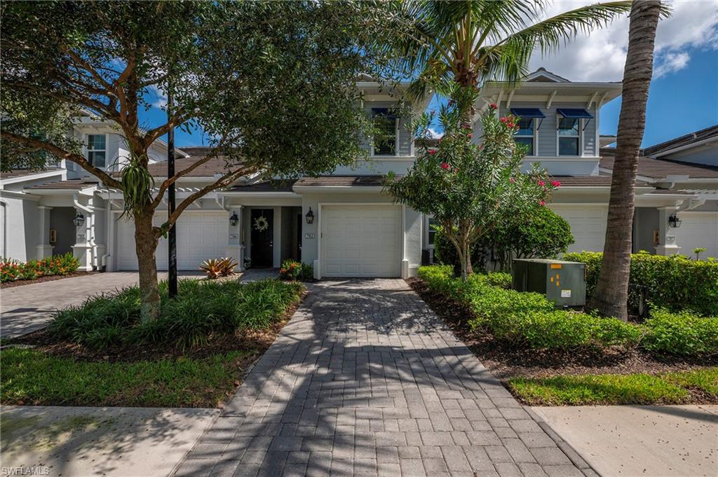6954 Avalon Circle, Unit 702 Naples, FL 34112 - Photo 22 of 40 a front view of a house with garden