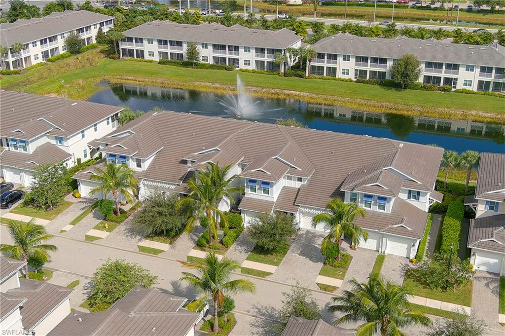 6954 Avalon Circle, Unit 702 Naples, FL 34112 - Photo 3 of 40 an aerial view of residential houses with yard and ocean view