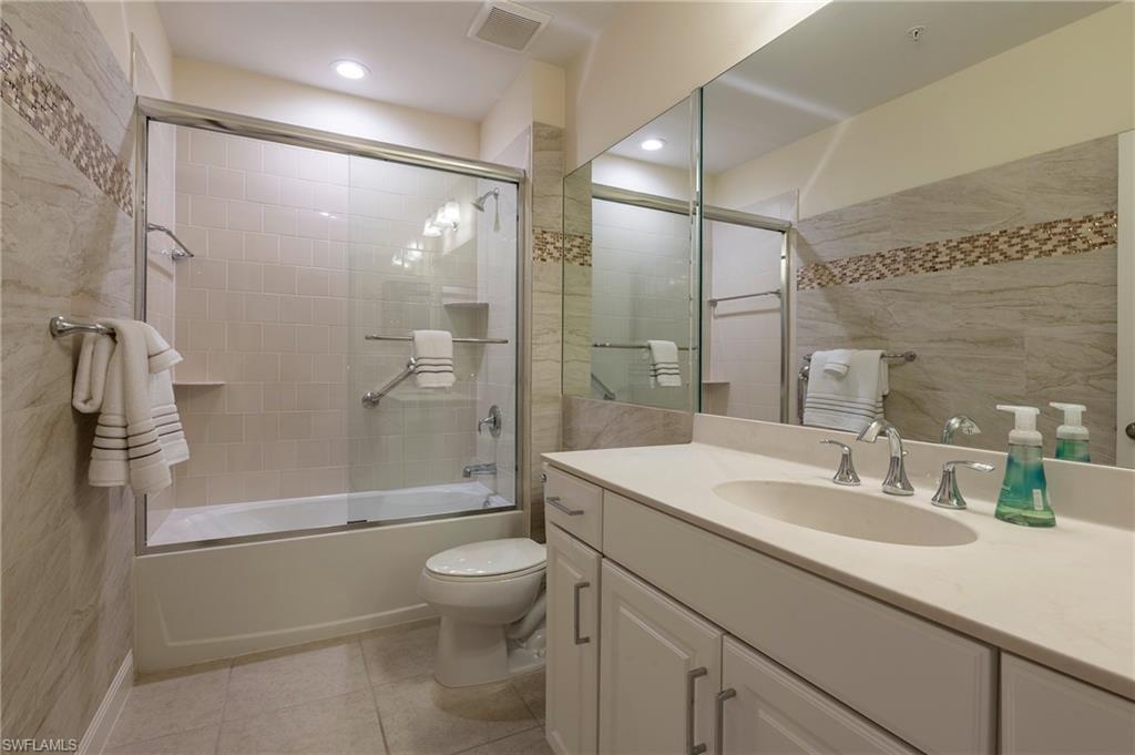 6954 Avalon Circle, Unit 702 Naples, FL 34112 - Photo 9 of 40 a bathroom with a sink a toilet and shower