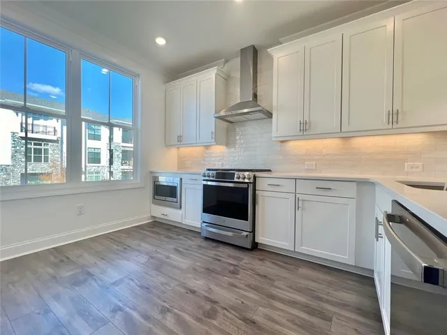 a kitchen with stainless steel appliances granite countertop a stove and a sink