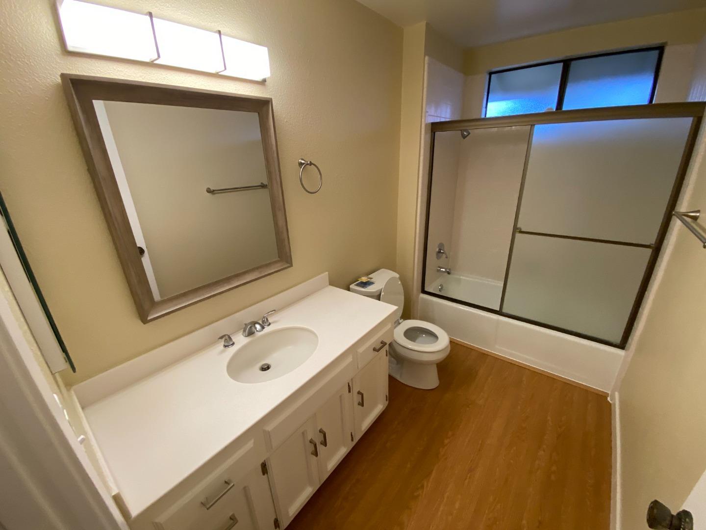 727 Montecito Way Salinas, CA 93901 - Photo 11 of 19 a bathroom with a sink and mirror with bathtub