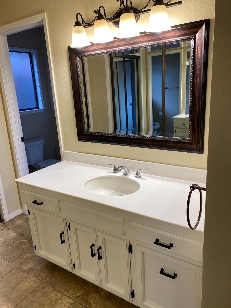 727 Montecito Way Salinas, CA 93901 - Photo 13 of 19 a bathroom with a sink and a mirror
