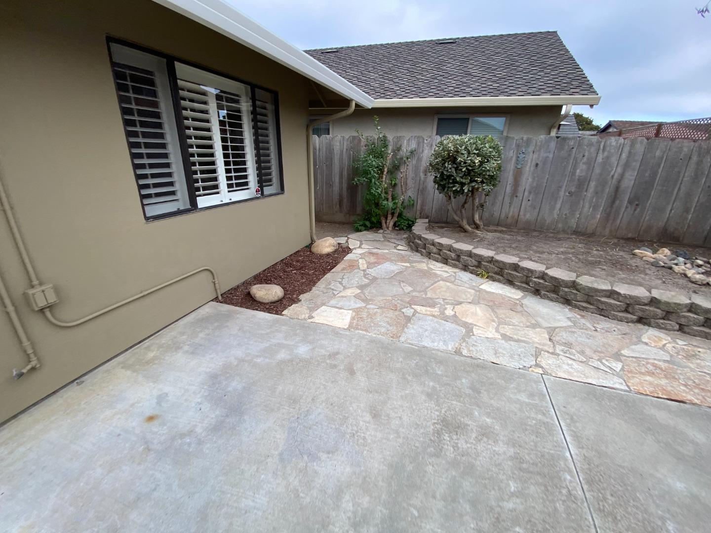 727 Montecito Way Salinas, CA 93901 - Photo 17 of 19 a view of backyard with potted plants and wooden fence