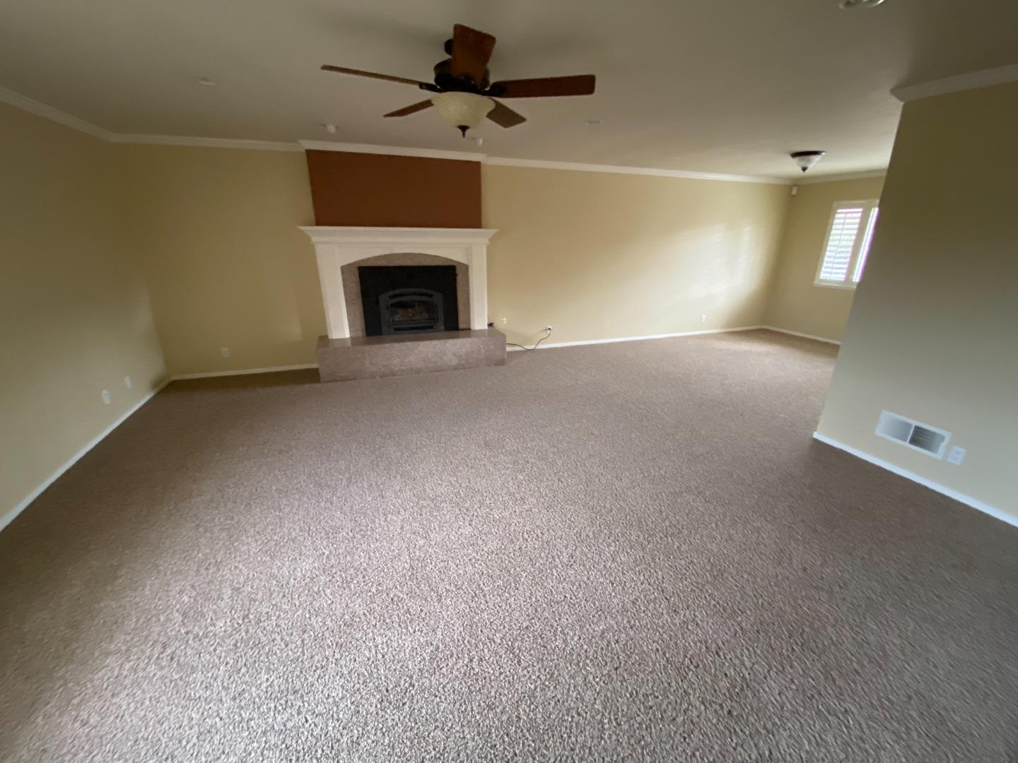 727 Montecito Way Salinas, CA 93901 - Photo 4 of 19 an empty room with fireplace and windows