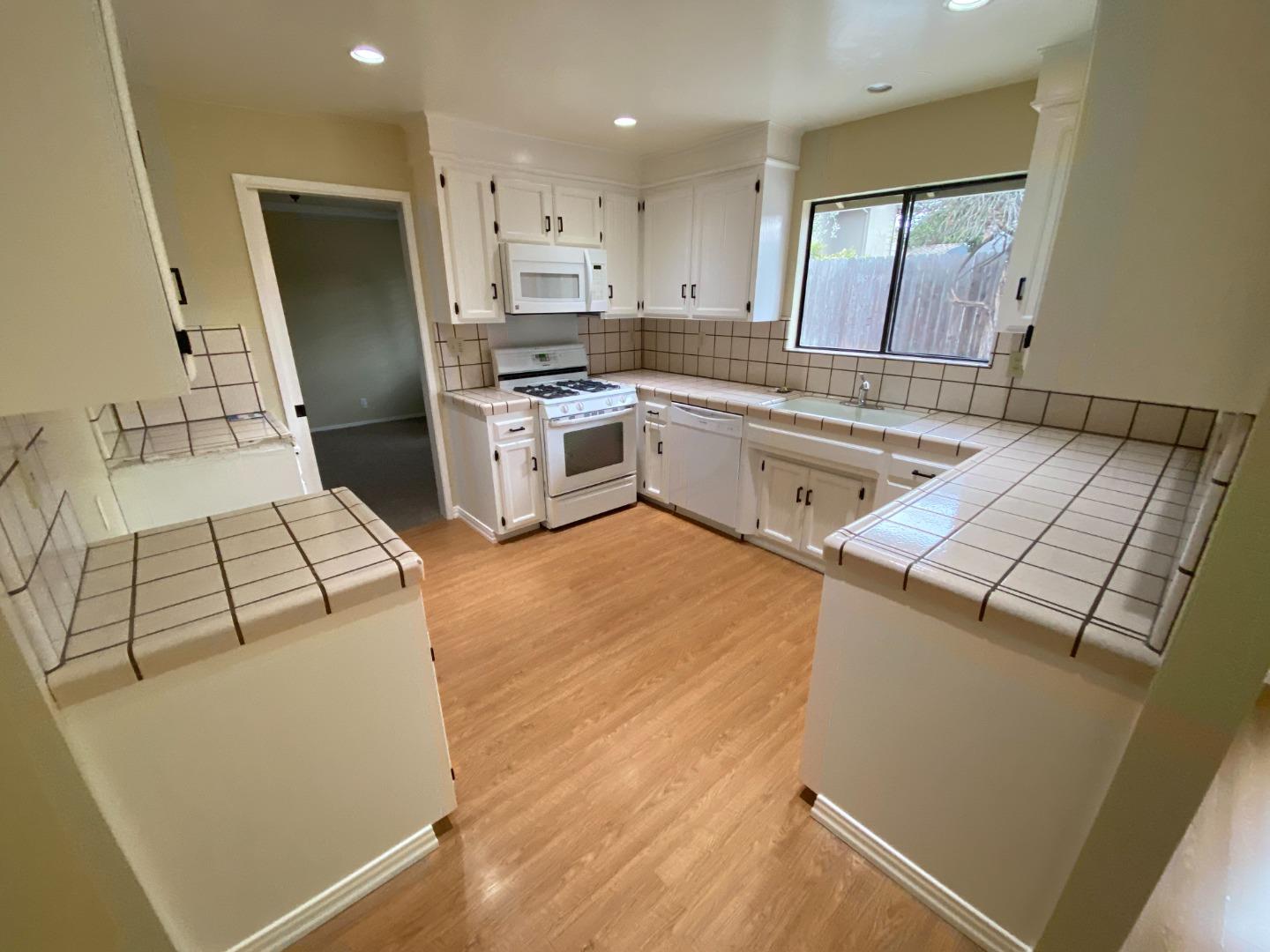 727 Montecito Way Salinas, CA 93901 - Photo 7 of 19 a kitchen with sink a microwave and refrigerator