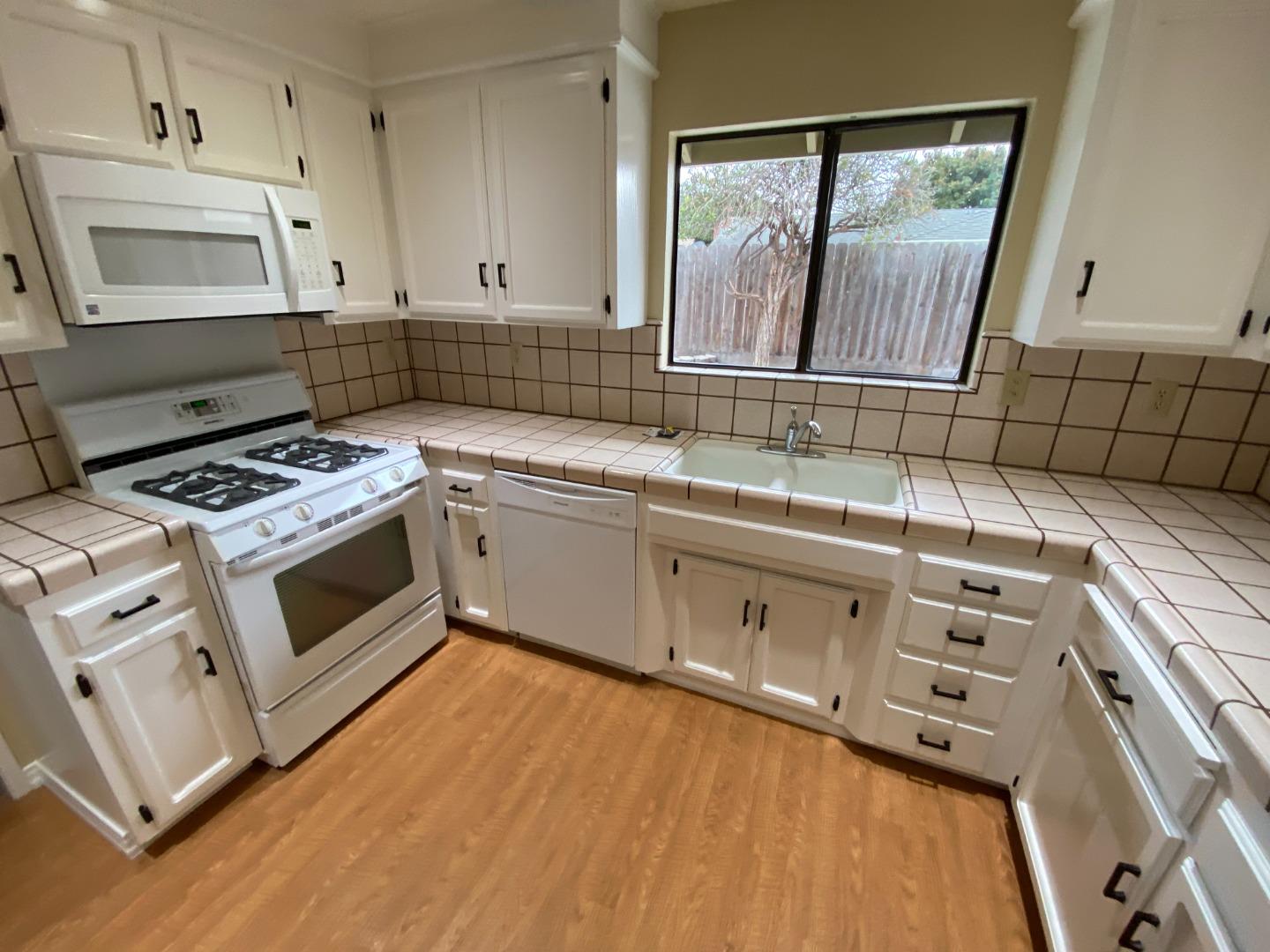 727 Montecito Way Salinas, CA 93901 - Photo 8 of 19 a kitchen with a sink stove and cabinets