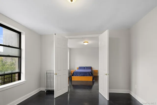 a hallway with sliding door and wooden floor