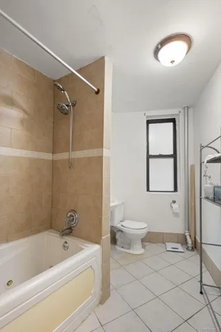a bathroom with a toilet a sink and bathtub