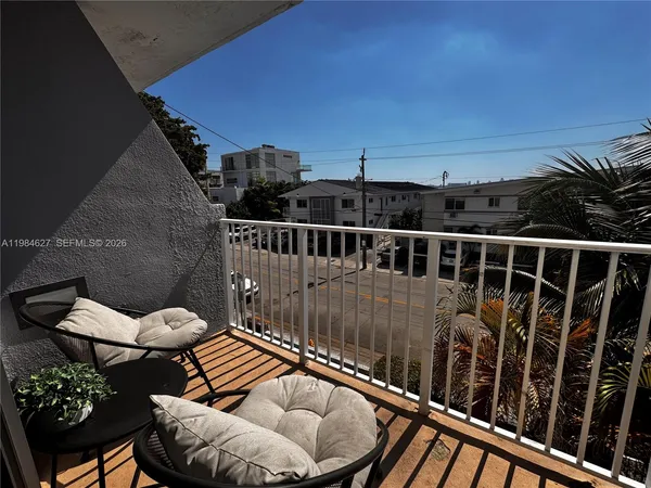 a view of a balcony with furniture