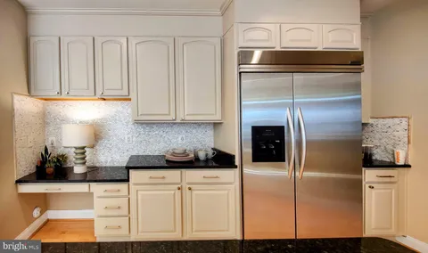 a kitchen with cabinets and stainless steel appliances