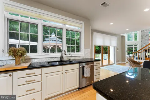 a kitchen with counter space and windows