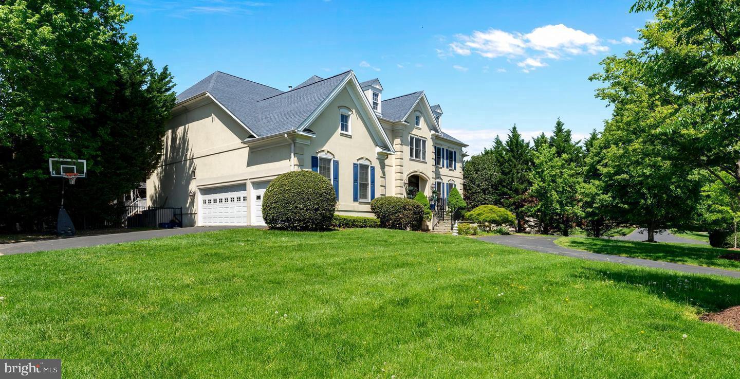 1445 Mayhurst Boulevard McLean, VA 22102 - Photo 2 of 31 a view of a house with a big yard and potted plants and large trees