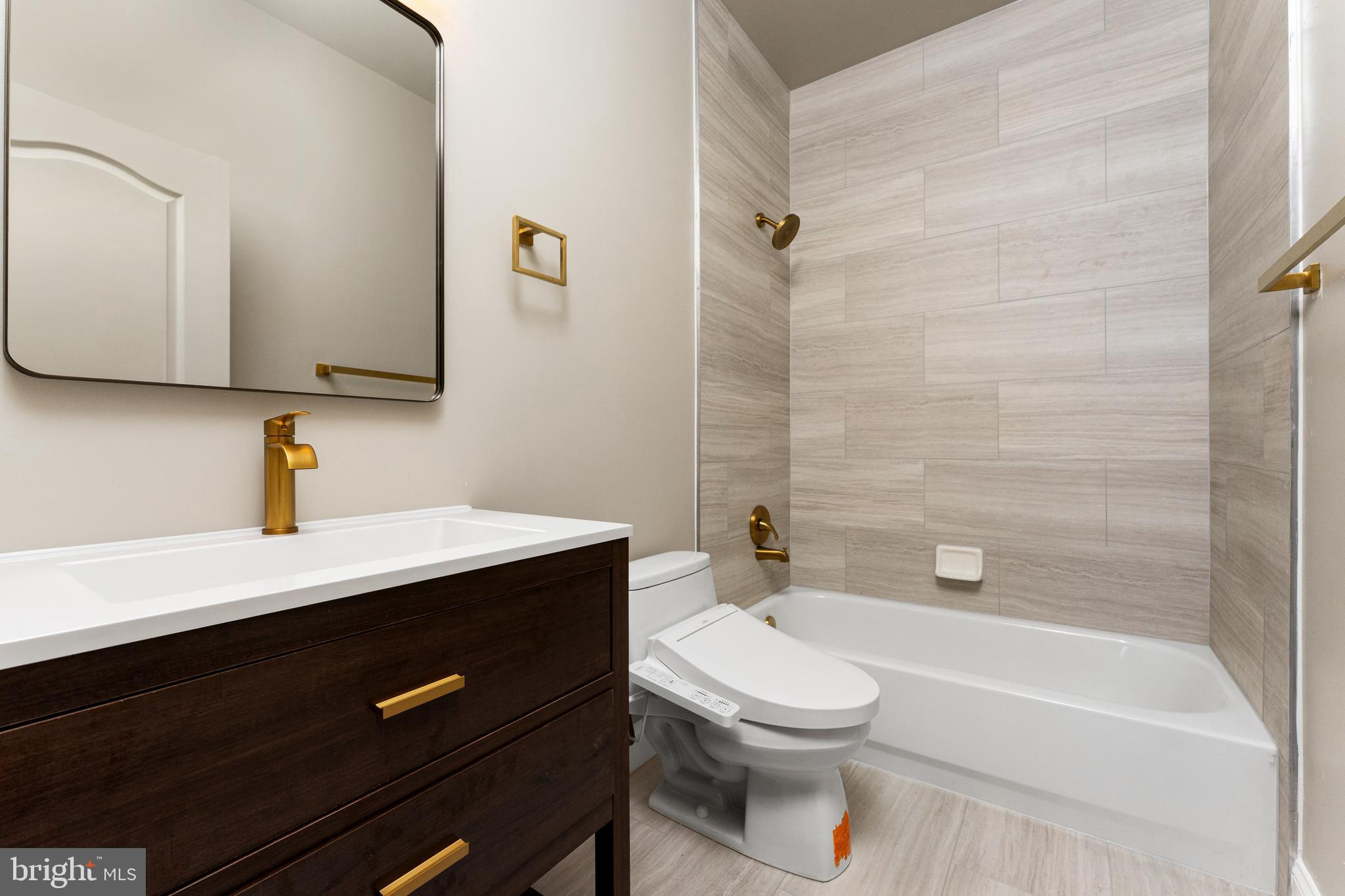 1445 Mayhurst Boulevard McLean, VA 22102 - Photo 28 of 31 a bathroom with a sink a toilet a mirror and shower