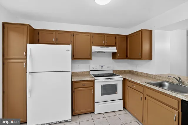 a white refrigerator freezer sitting in a kitchen