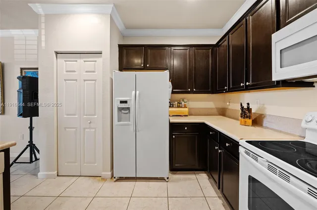 a kitchen with stainless steel appliances a refrigerator sink and cabinets