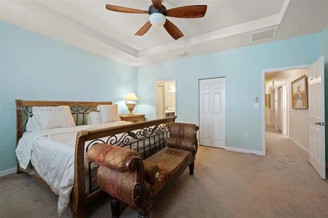 a bedroom with a bed and painting on the wall