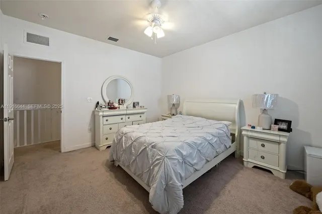 a bedroom with a bed and a view of utility room