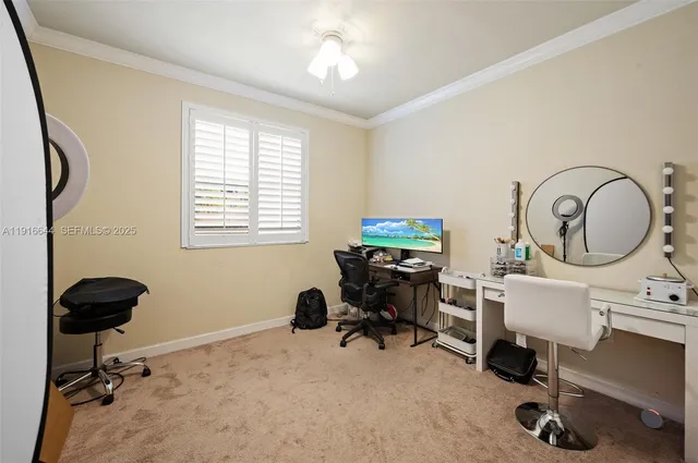a view of a workspace with furniture and a window