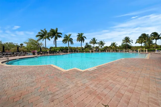 an aerial view of a house with a yard and lake view