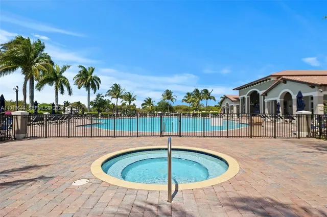 a swimming pool with outdoor seating and yard