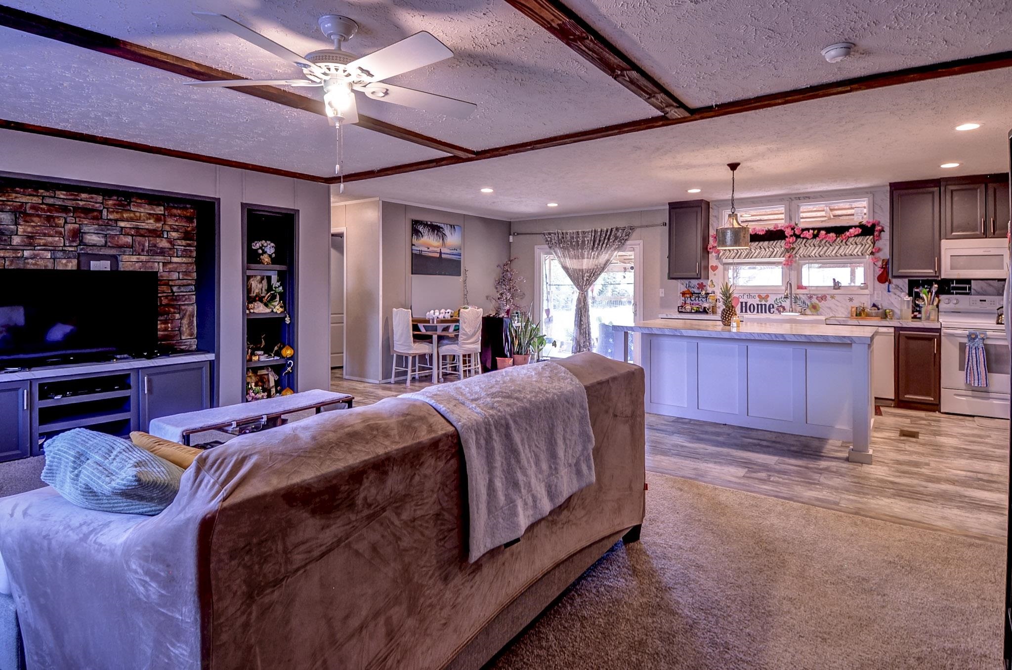 2450 South Neely Road Middleton, TN 38052 - Photo 16 of 38 Living room featuring a textured ceiling, light colored carpet, and ceiling fan