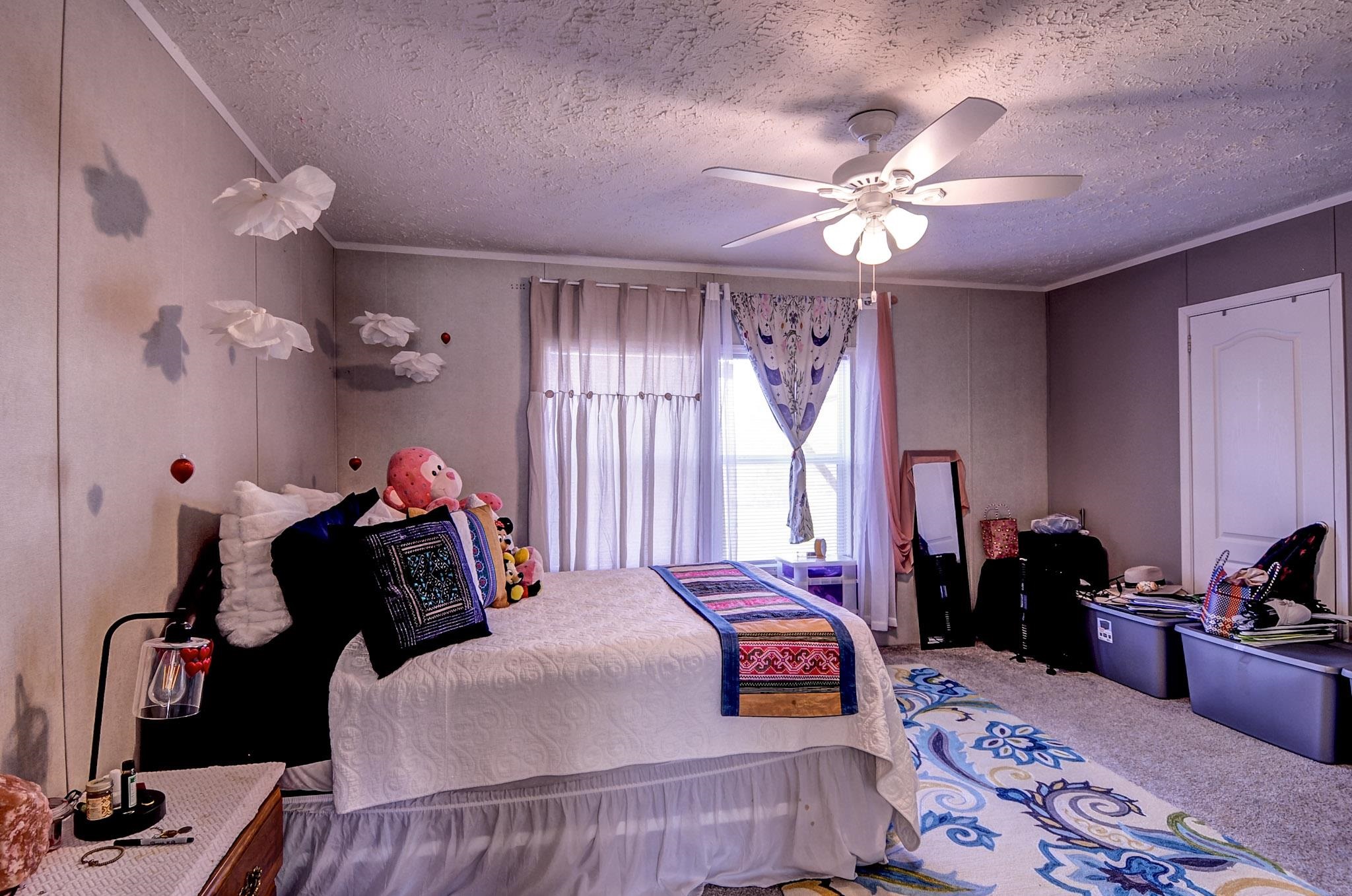 2450 South Neely Road Middleton, TN 38052 - Photo 19 of 38 Carpeted bedroom featuring a textured ceiling, a ceiling fan, and ornamental molding