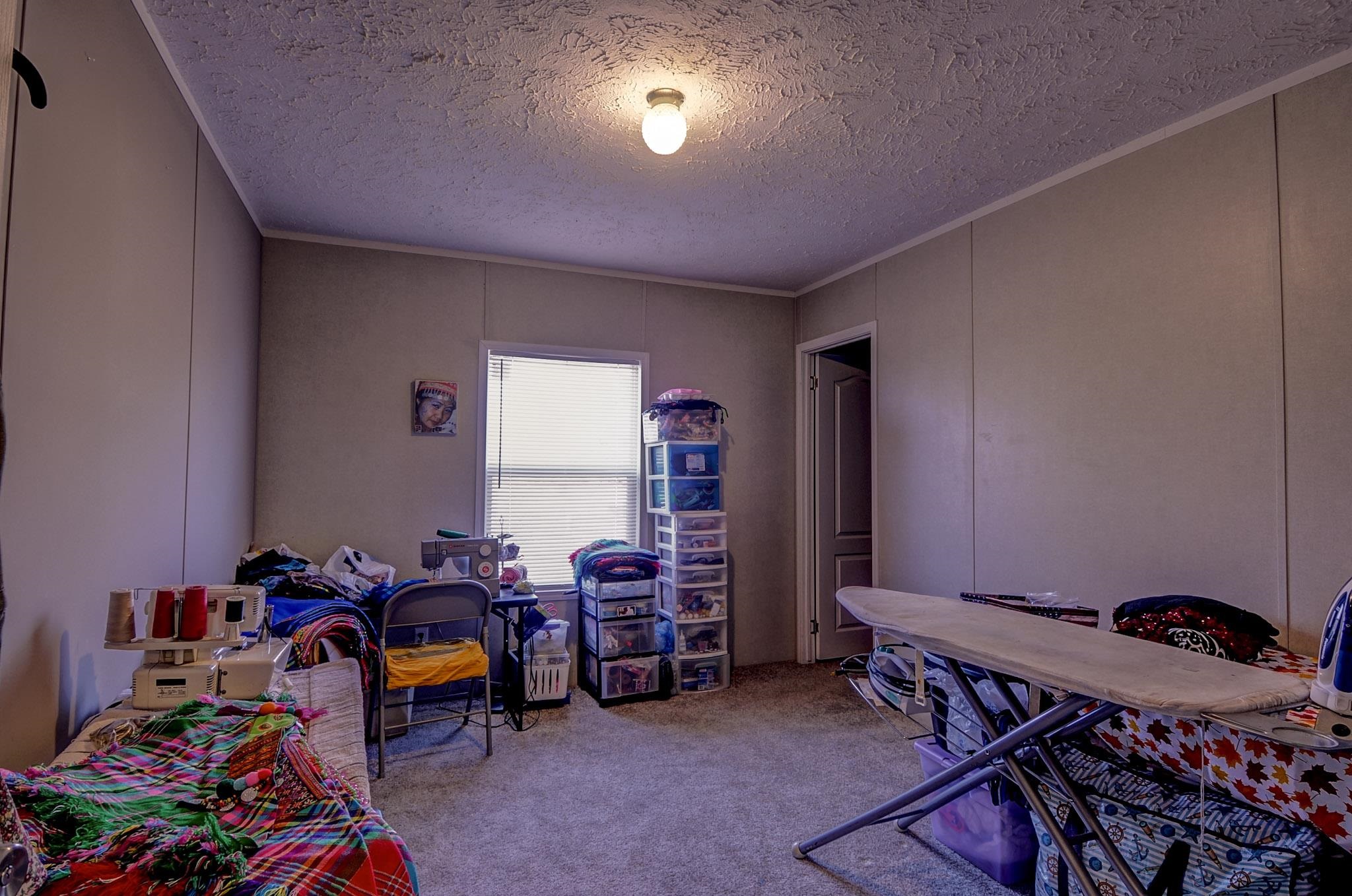 2450 South Neely Road Middleton, TN 38052 - Photo 29 of 38 Office featuring a decorative wall, a textured ceiling, carpet flooring, and ornamental molding