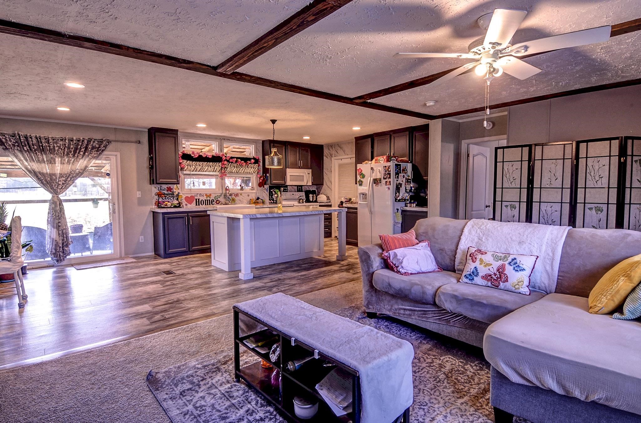 2450 South Neely Road Middleton, TN 38052 - Photo 4 of 38 Living room with a textured ceiling, ceiling fan, and dark wood-style floors