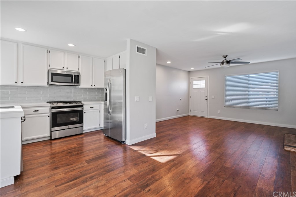 4435 Springtime Drive Oceanside, CA 92056 - Photo 12 of 52 a kitchen with granite countertop a refrigerator and a stove top oven