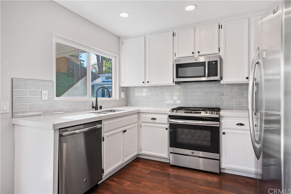 4435 Springtime Drive Oceanside, CA 92056 - Photo 13 of 52 a kitchen with stainless steel appliances granite countertop a stove a sink and a refrigerator