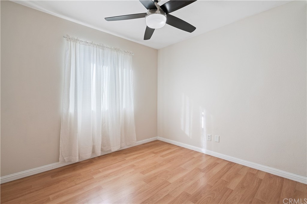 4435 Springtime Drive Oceanside, CA 92056 - Photo 17 of 52 an empty room with wooden floor fan and windows